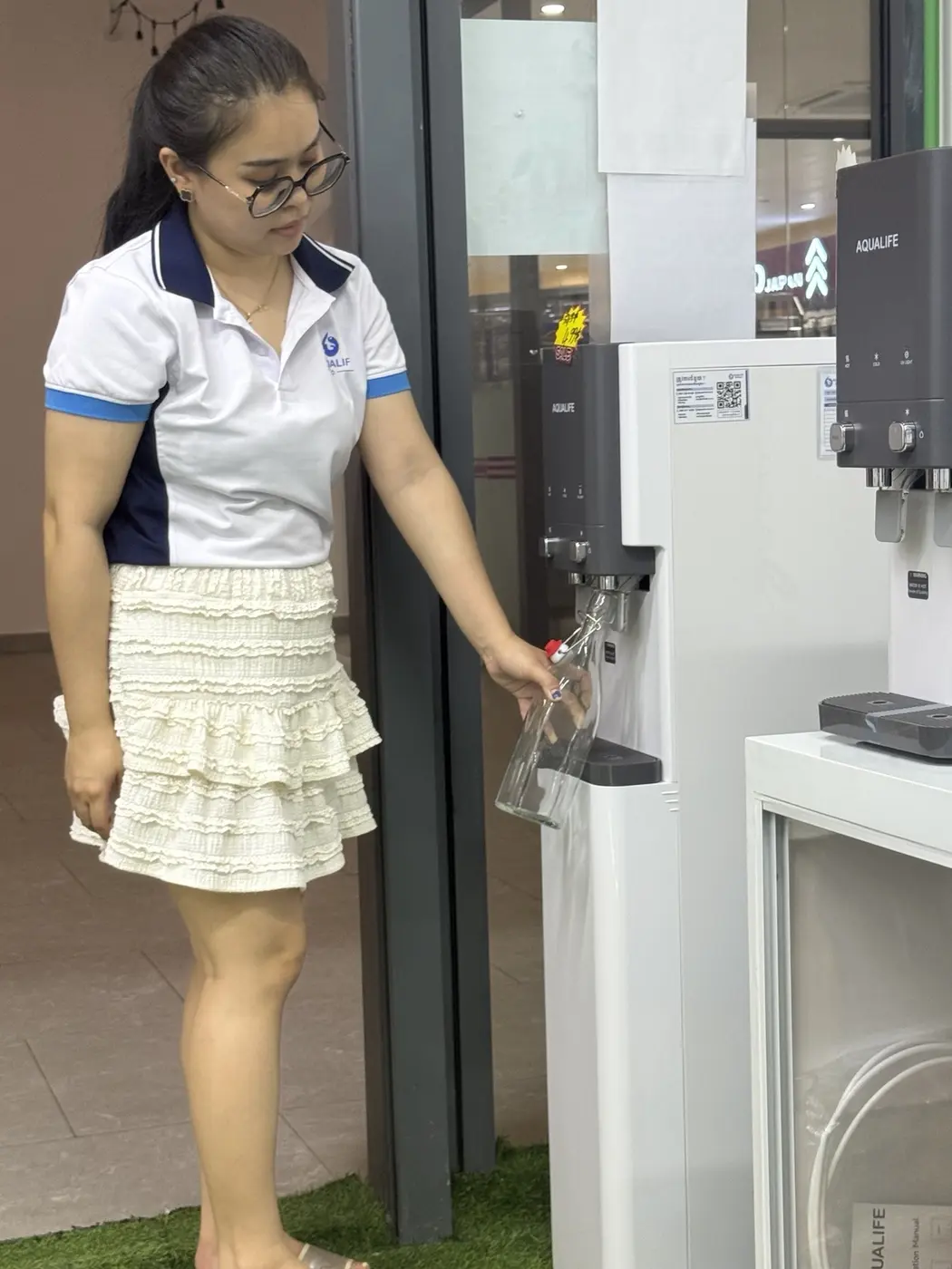 Muyleang demonstrating Aqualife water service at the UV Branch
